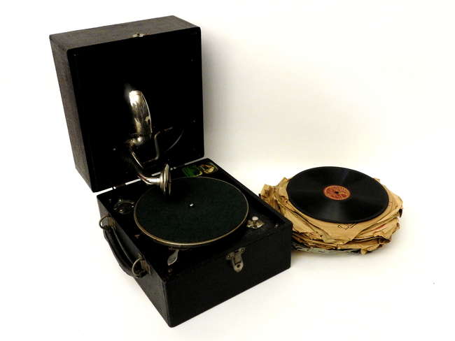 An Alba piccolo record player and records