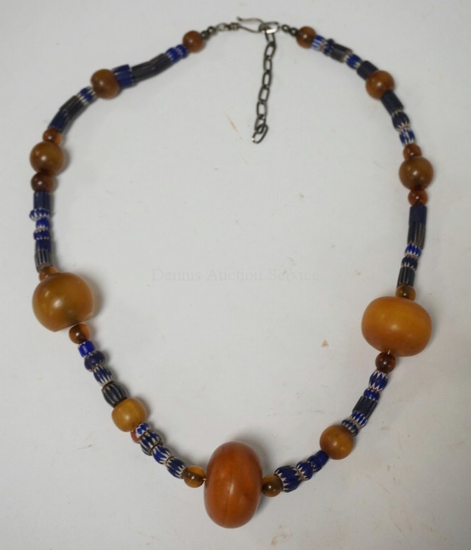 BEADED NECKLACE HAVING ANTIQUE AMBER AND CHEVRON TRADE BEADS.