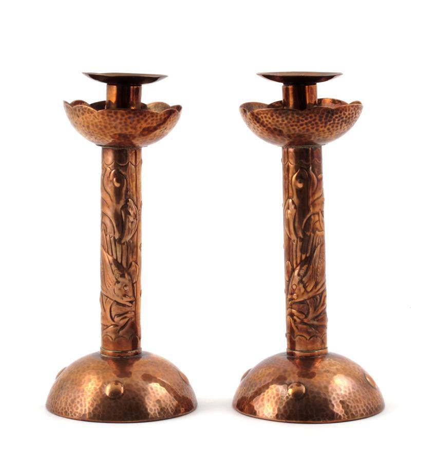 A pair of Newlyn copper candlesticks