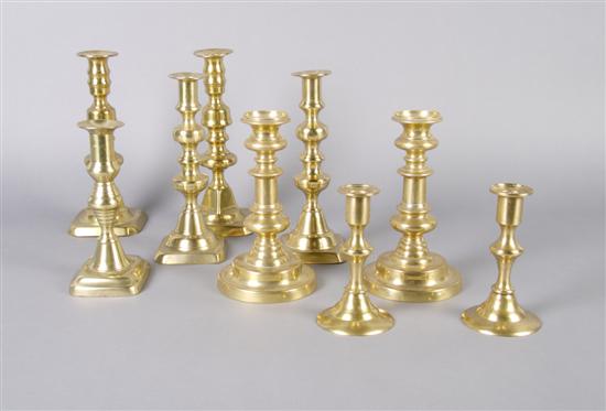 Four Pairs of Brass Candlesticks, together with a single candlestick.