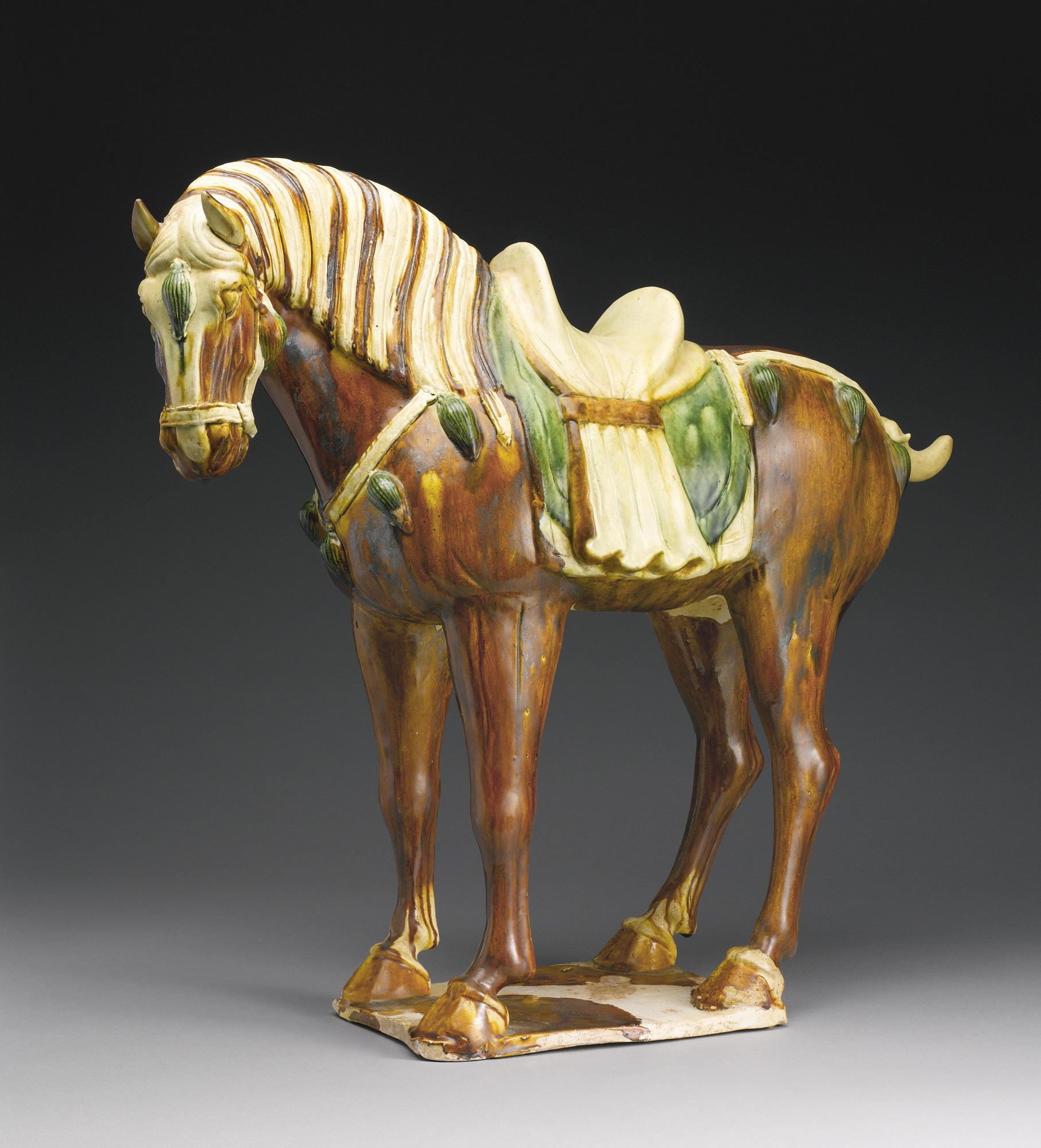 A sancai-glazed pottery figure of a horse tang dynasty