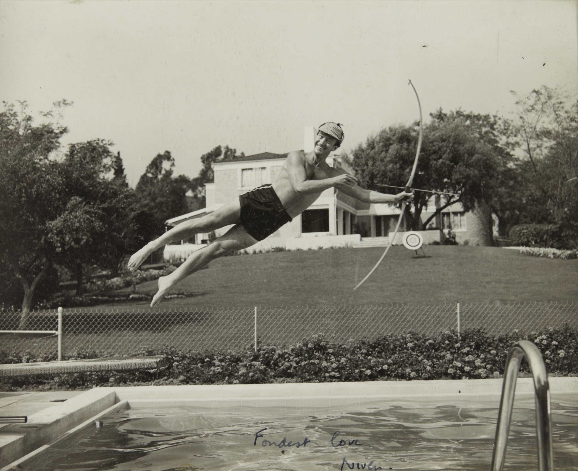 Photograph of David Niven Jumping Into a Swimming Pool