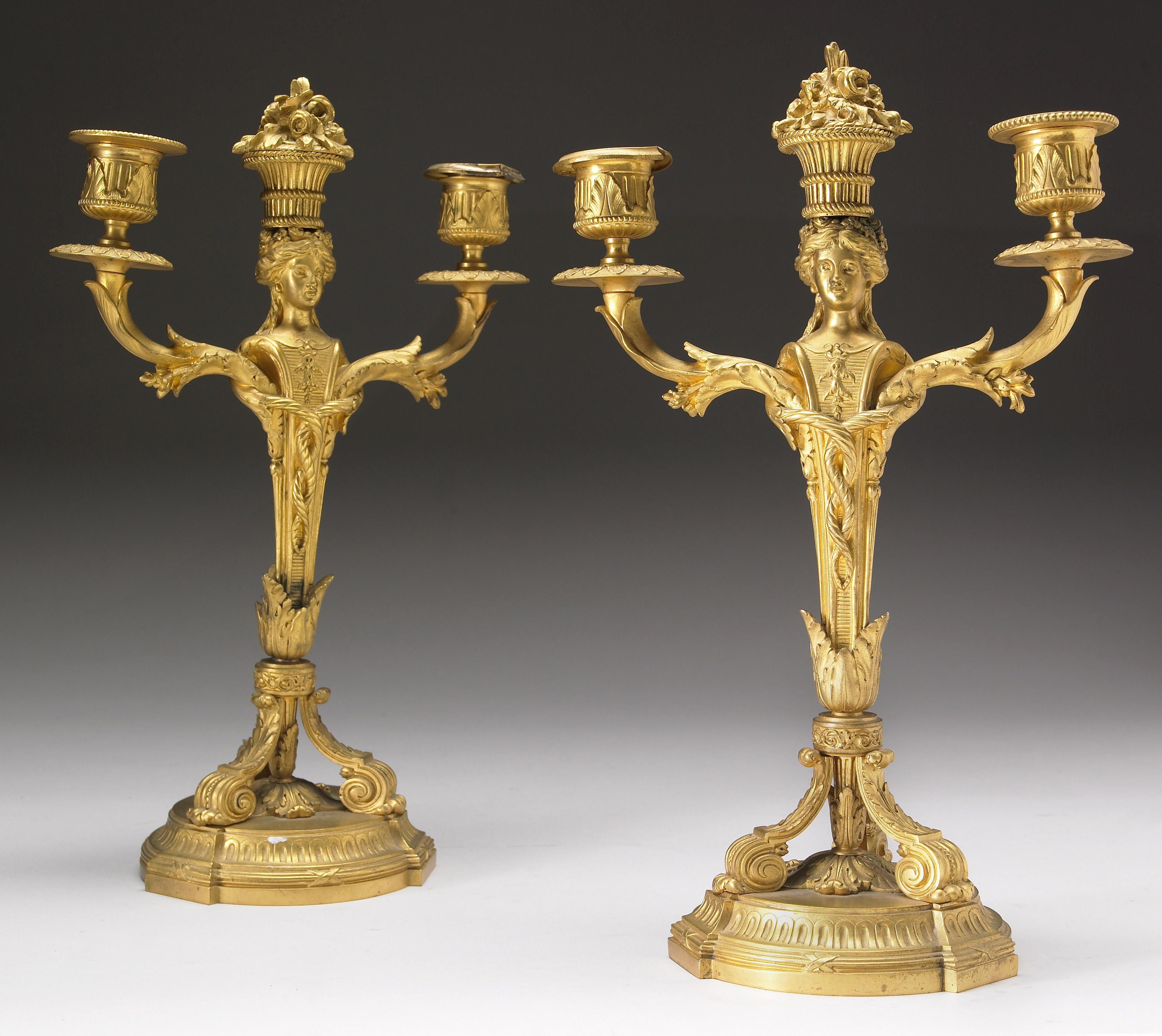 A pair of Louis XVI style gilt bronze candelabra