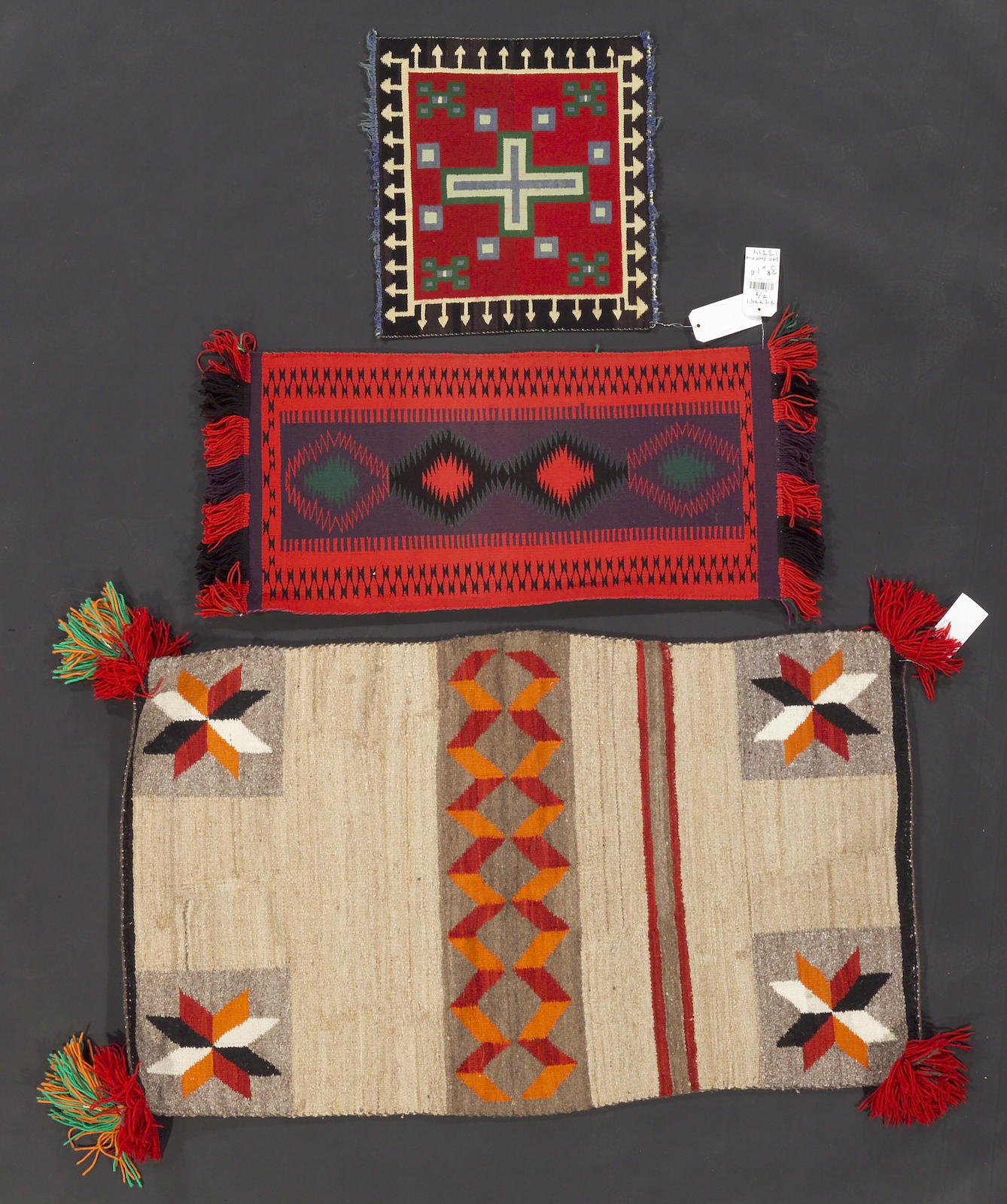 Three Navajo rugs, 4ft 8in x 2ft 7in, 3ft 8in x 1ft 6in, 1ft 9in x 1ft 7in