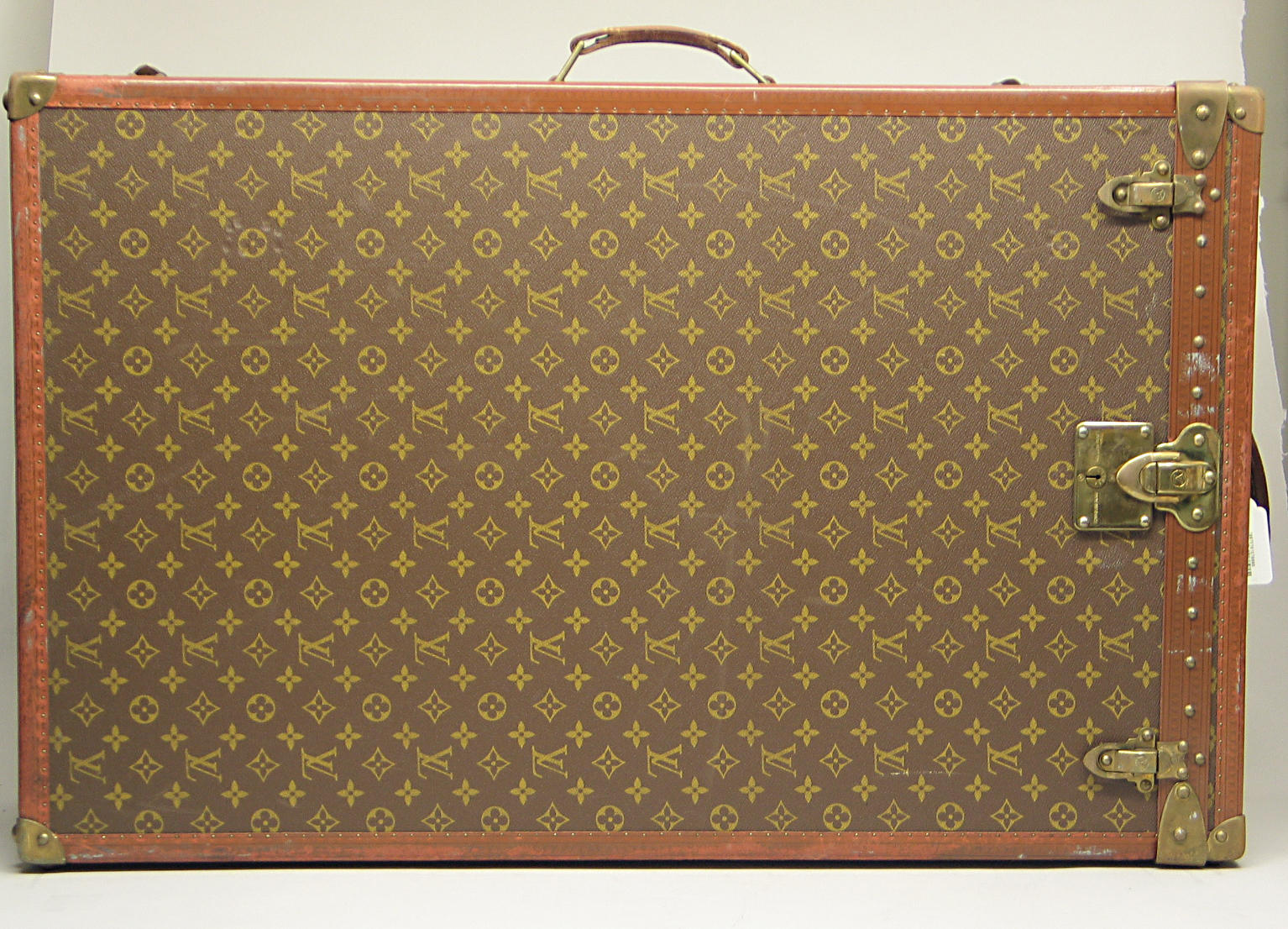 A Louis Vuitton hard sided suitcase trunk