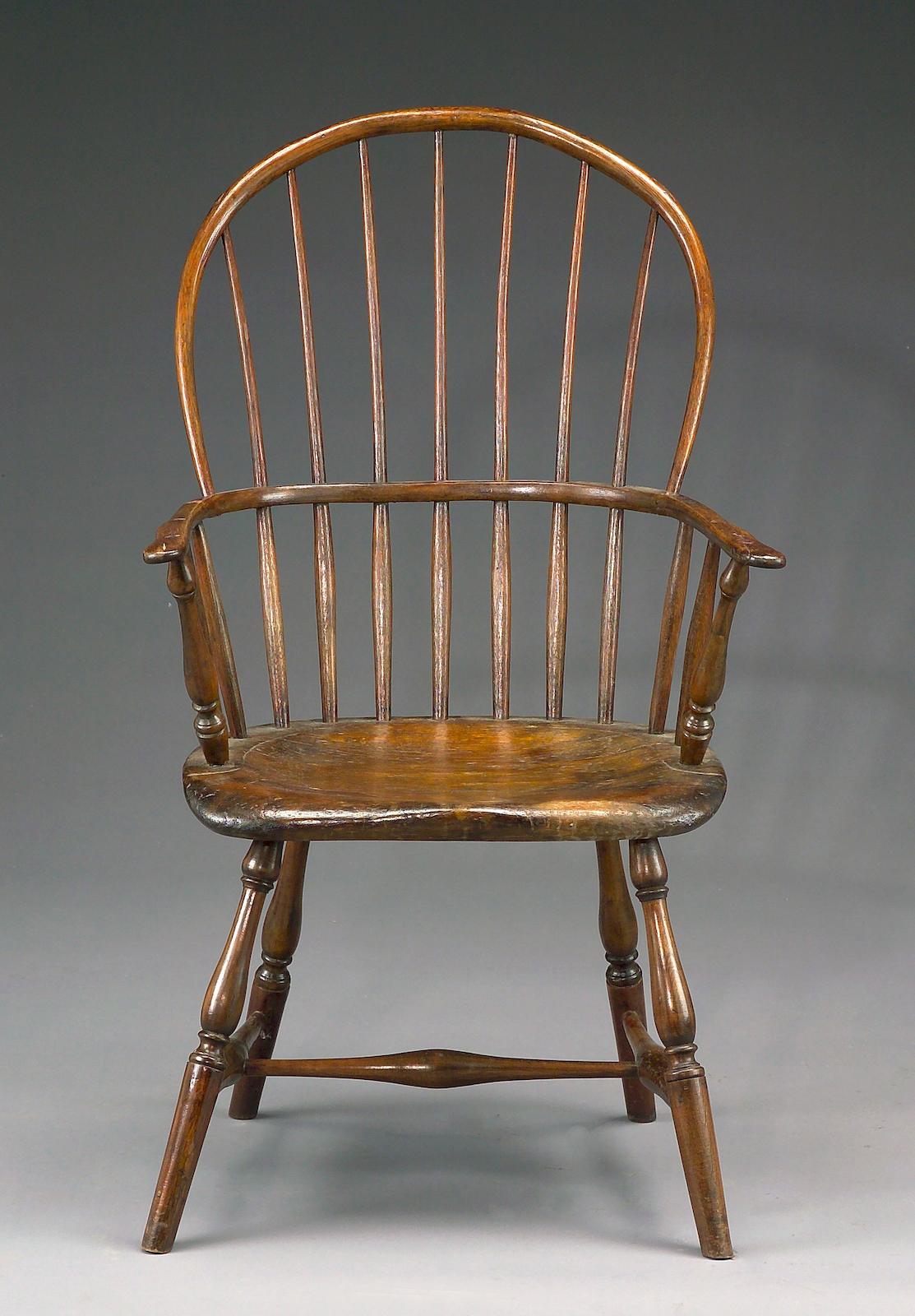 A mixed wood sack back Windsor chair