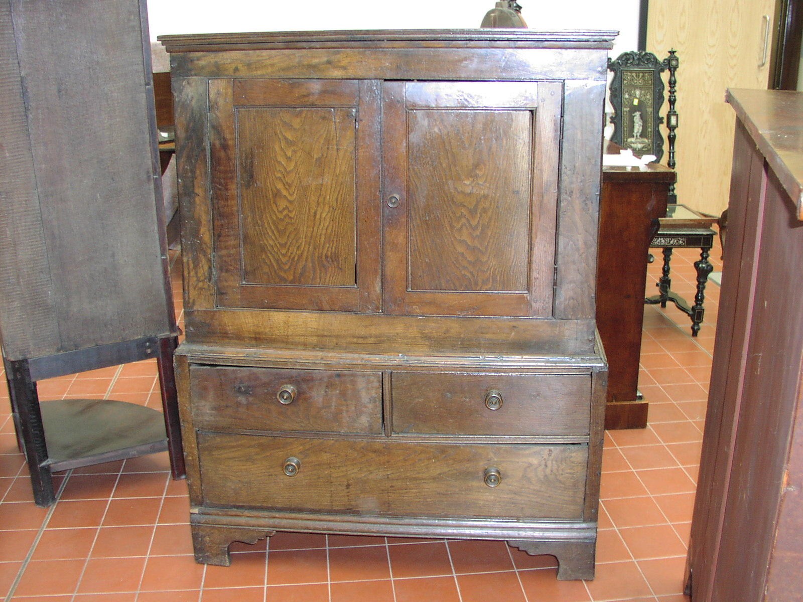 A small antique oak panelled dwarf cupboard,