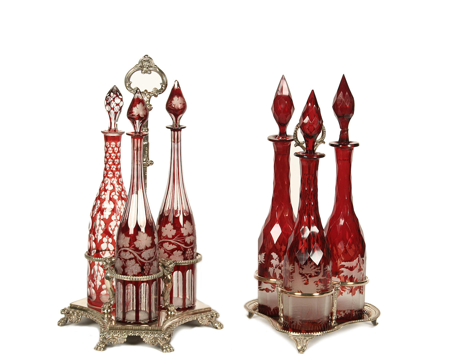 Six various Bohemian ruby flashed decanters in two silver plated decanter stands