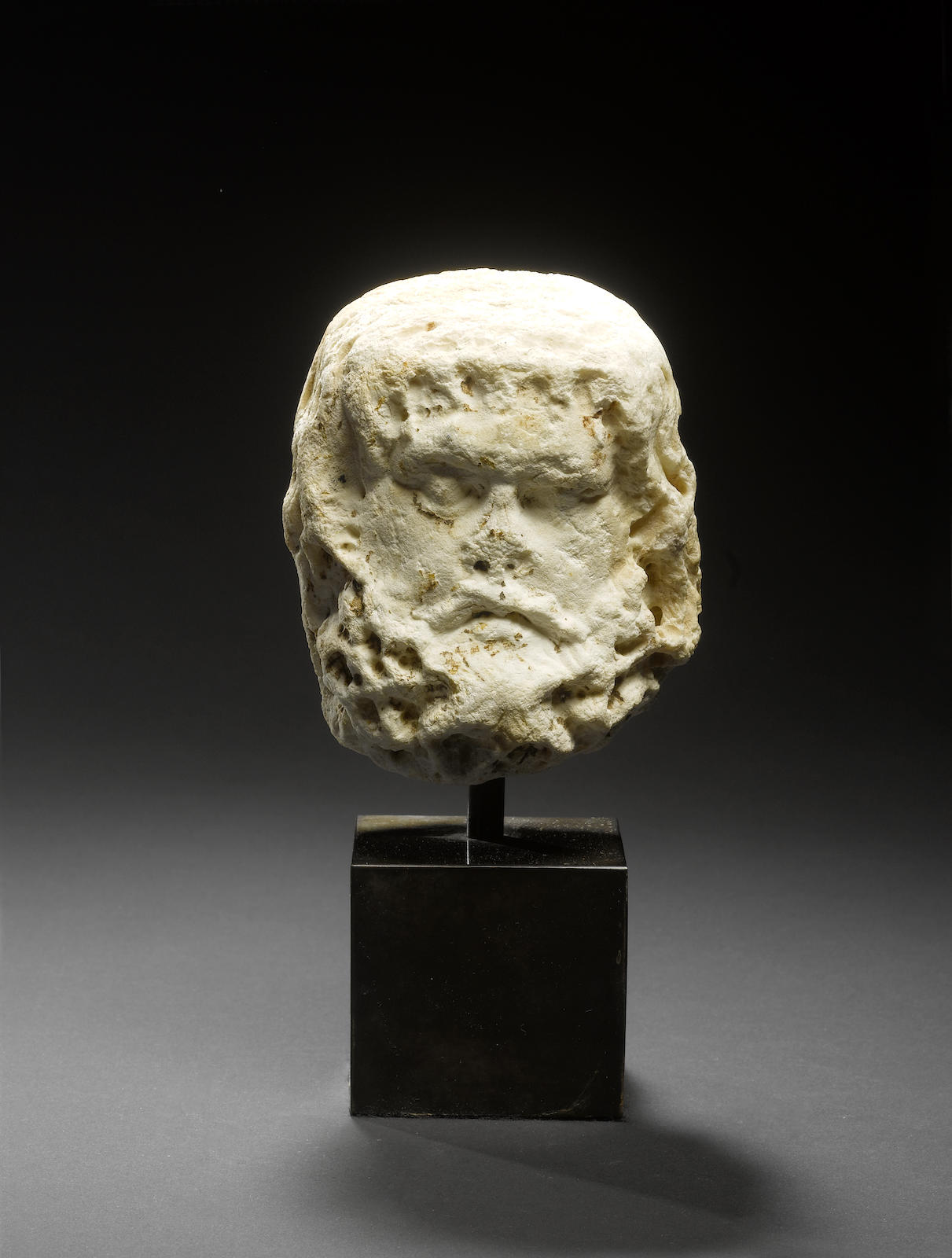 A Roman limestone head of Silenus
