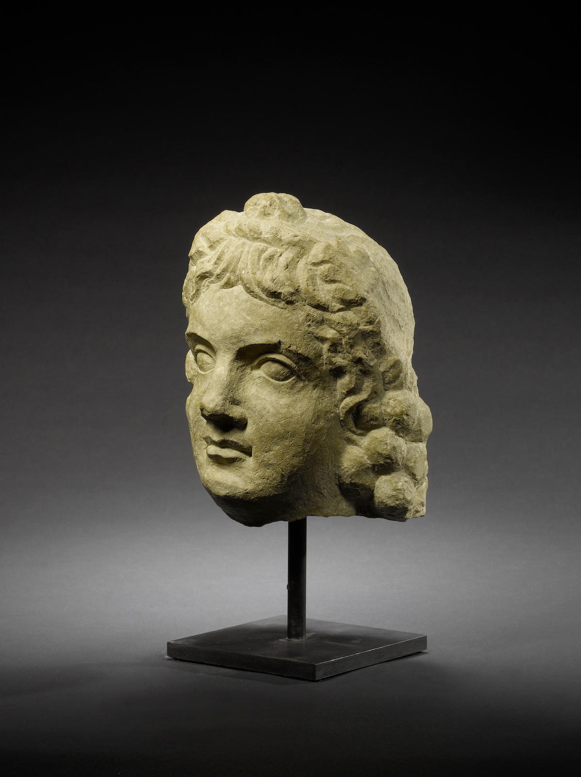 A Roman limestone head of Bacchus