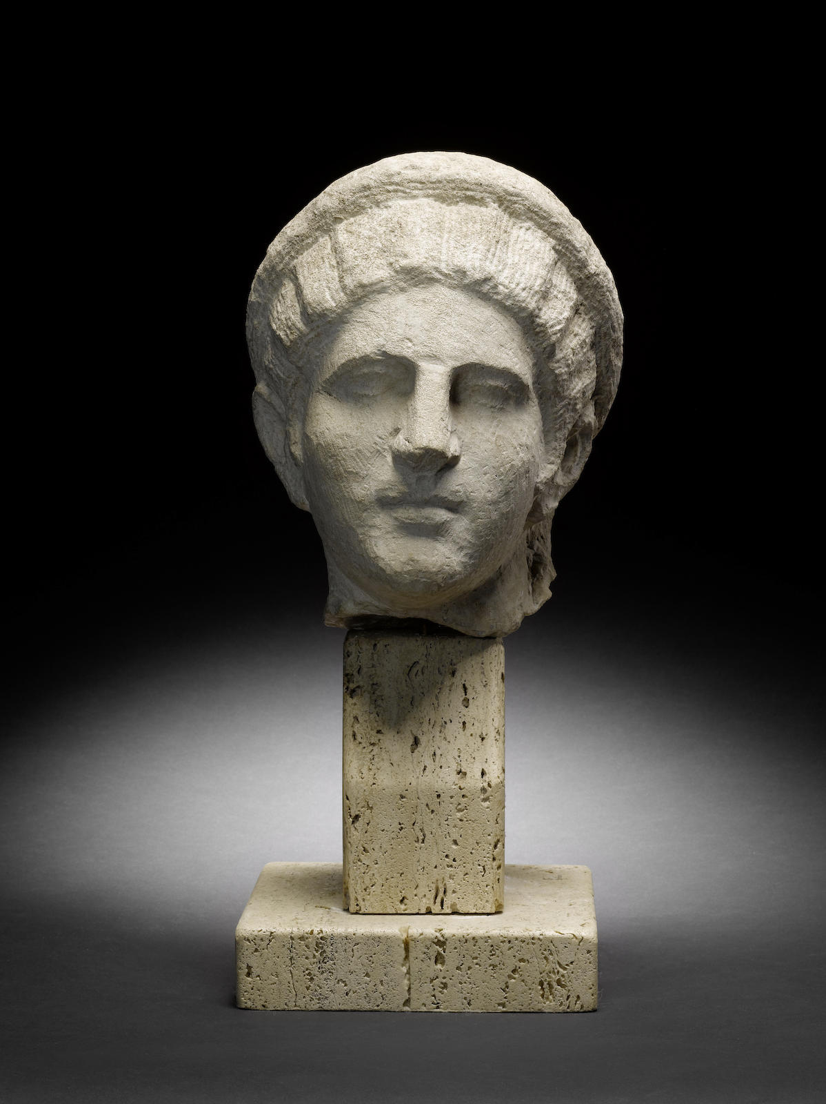 A Roman limestone female head