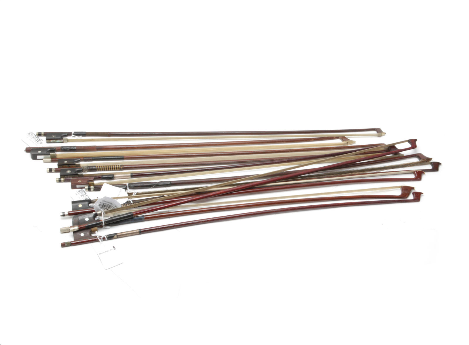 A collection of eight violin bows and three cello bows,