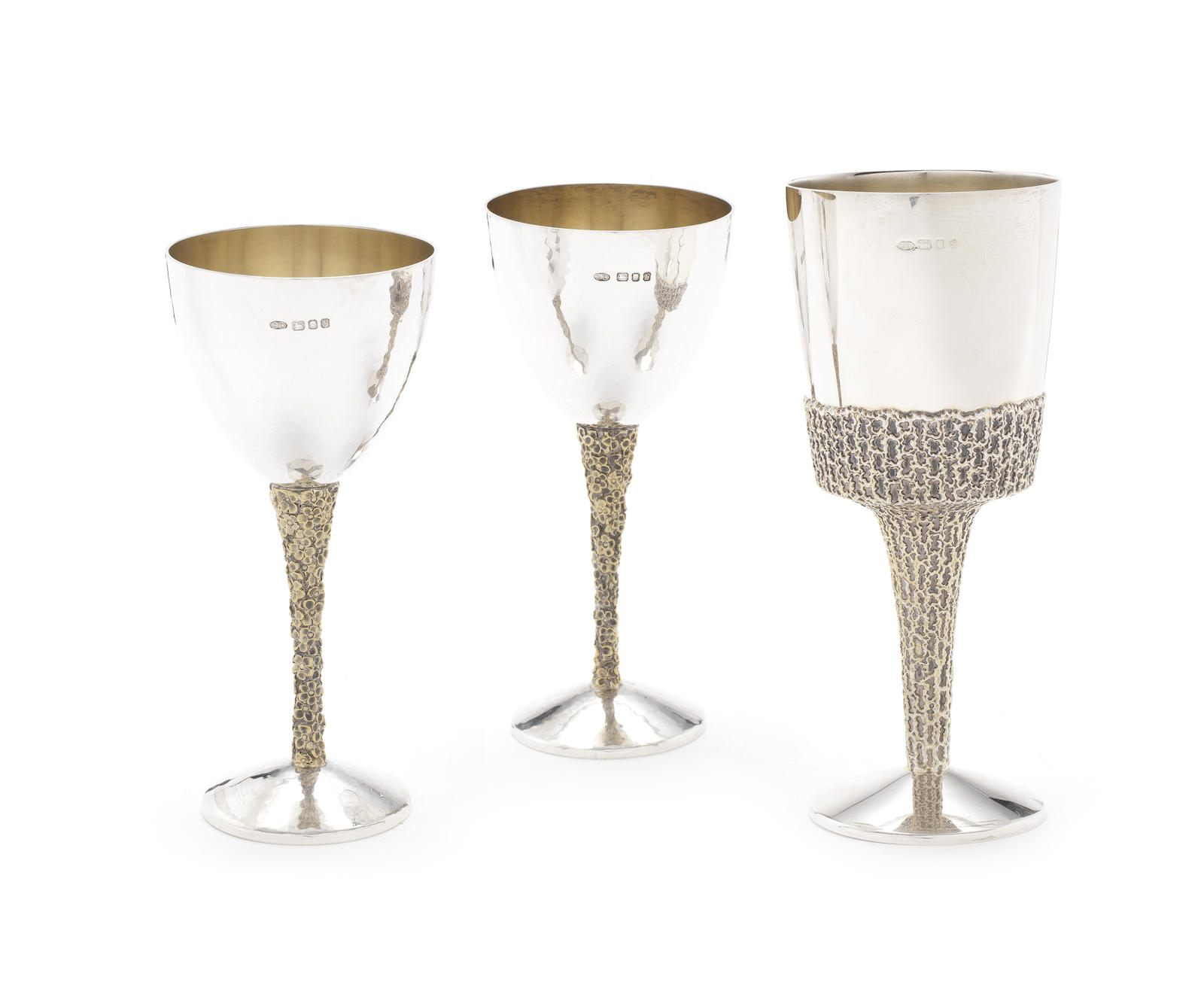 STUART DEVLIN: A pair of silver and silver-gilt goblets London 1976 together with another silver and silver-gilt goblet, by Stuart Devlin, London 1973 (3)