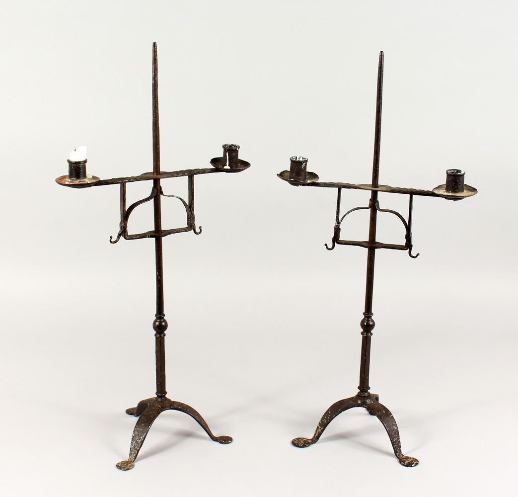 TWO 18TH/19TH CENTURY WROUGHT IRON CANDLESTICKS, on