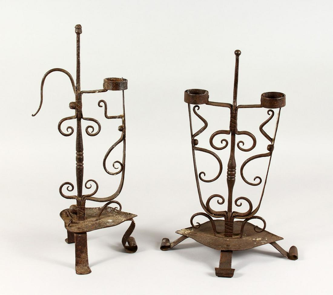 TWO 18TH/19TH CENTURY WROUGHT IRON CANDLESTICKS, on