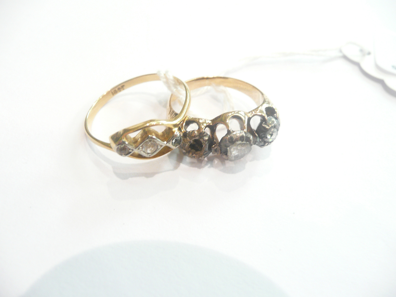 A Georgian three stone ring (one stone missing) and a three stone twist ring
