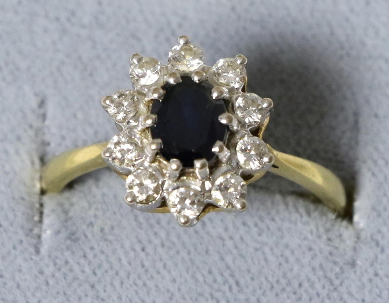 An 18 carat gold sapphire and diamond cluster ring