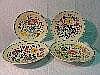 Four Poole Pottery chargers in white earthenware,