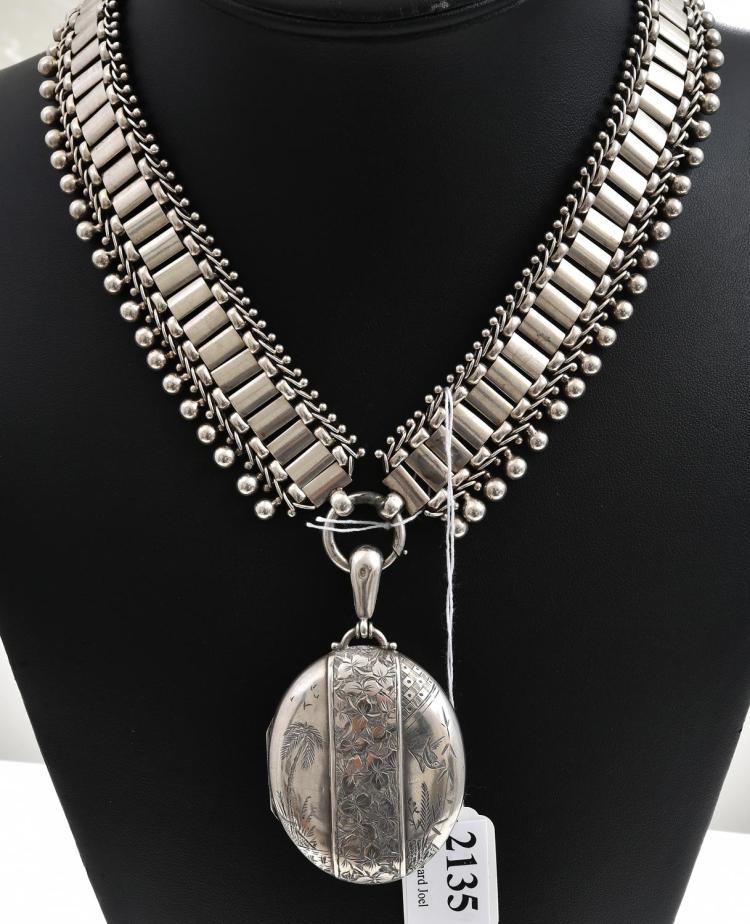 A STERLING SILVER LOCKET AND CHAIN