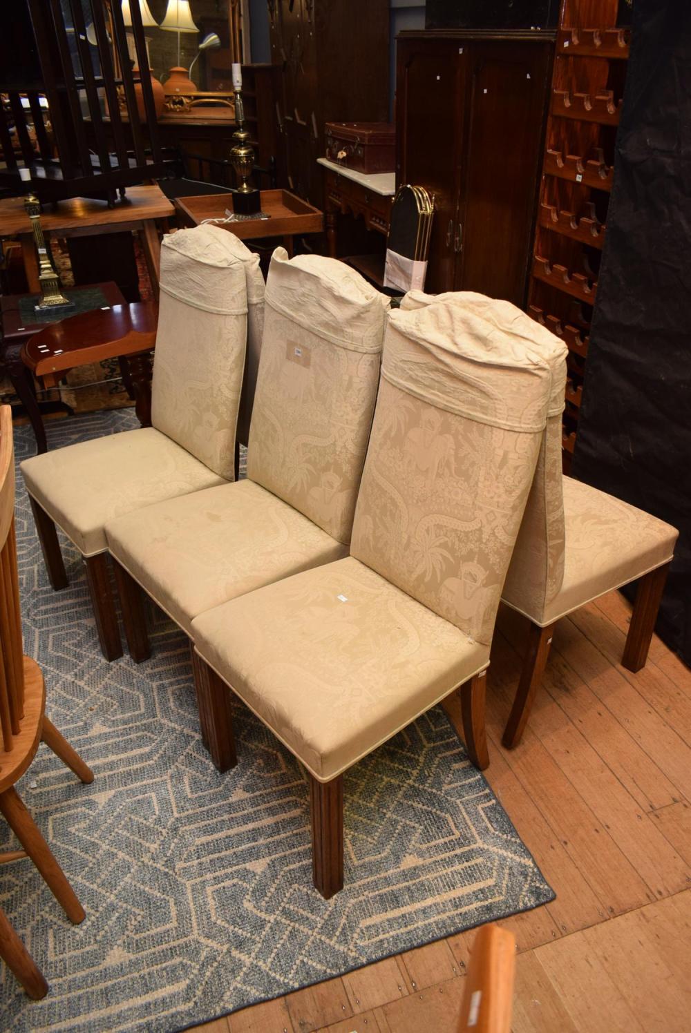 A SET OF SIX UPHOLSTERED DINING CHAIRS