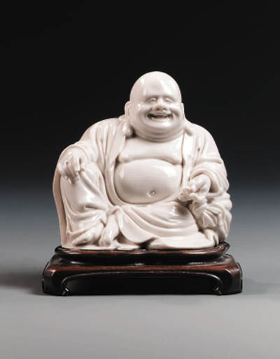 A DEHUA BLANC-DE-CHINE SEATED FIGURE OF BUDAI