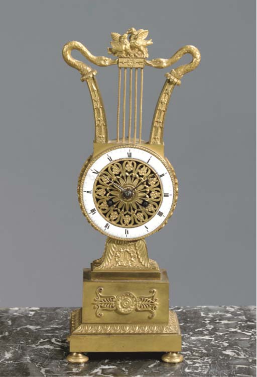A FRENCH EMPIRE ORMOLU STRIKING MANTEL CLOCK
