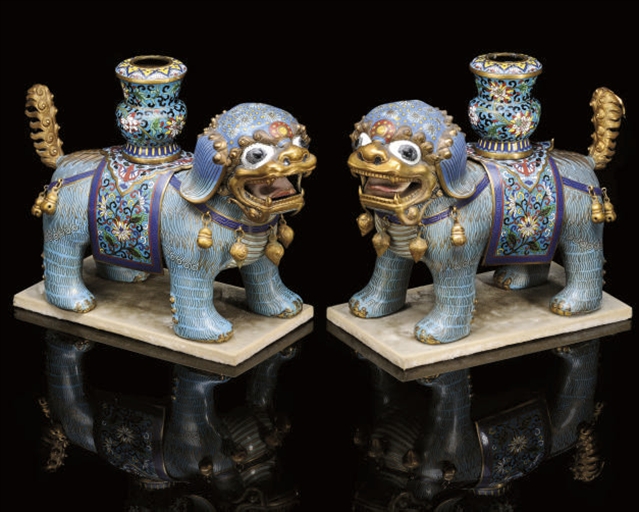 A PAIR OF CLOISONNE ENAMELLED CAPARISONED BUDDHISTIC LION CANDLE HOLDERS, 19TH/20TH CENTURY