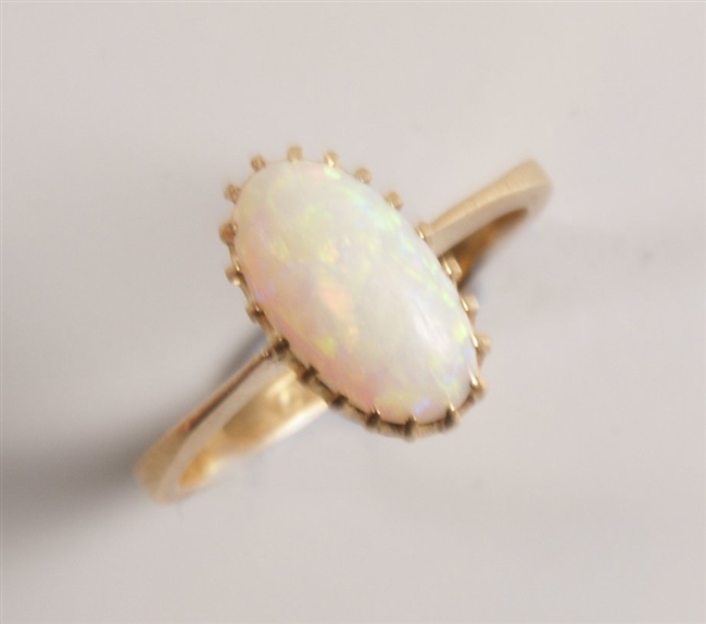 18ct gold opal set ring, an oval opal cabochon in