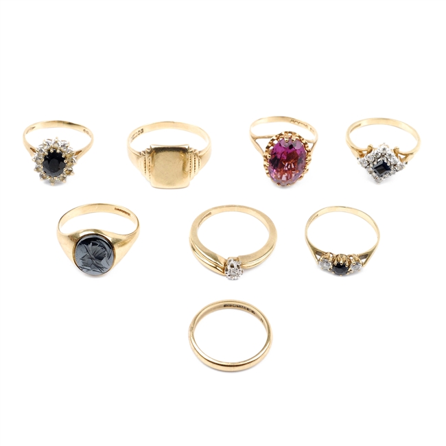 A collection of eight 9ct gold rings.