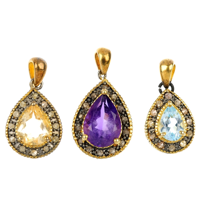 Three gem-set pendants.