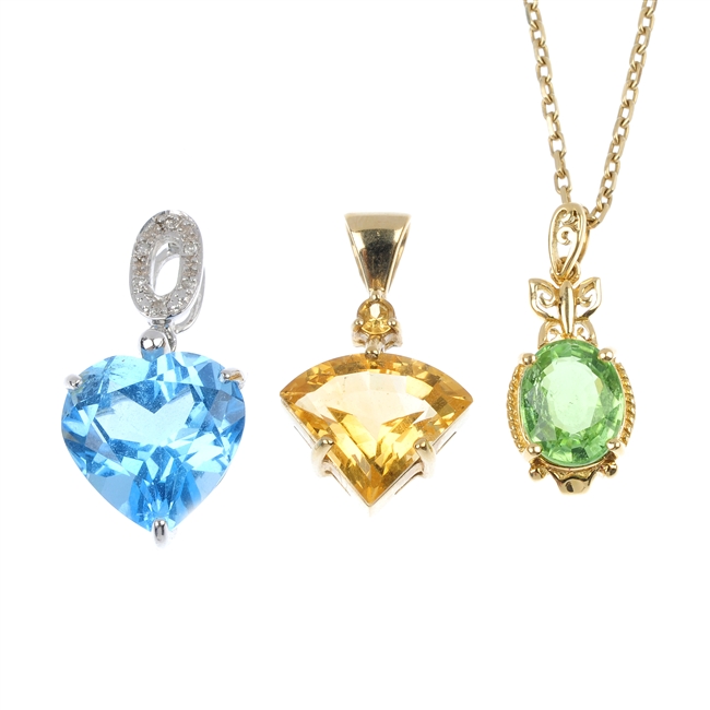 An assortment of three 9ct gold gem-set pendants.