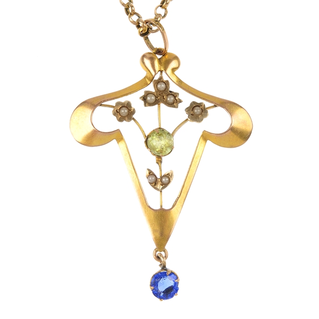 A selection of three gold gem-set pendants.