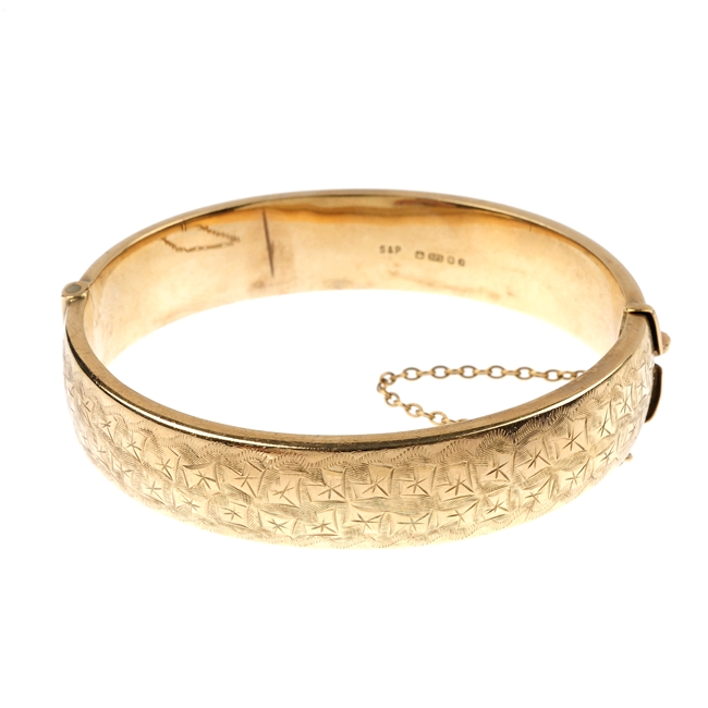 A 9ct gold hinged bangle.