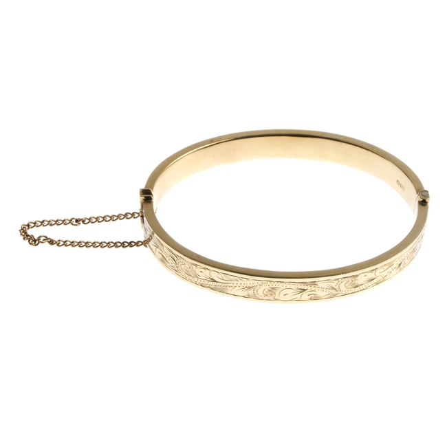 A 9ct gold hinged bangle.