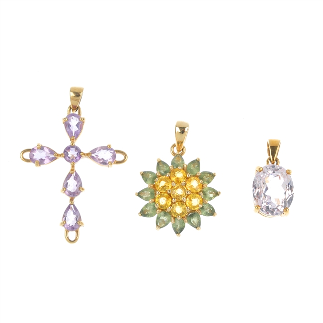 A selection of three 9ct gold gem-set pendants.