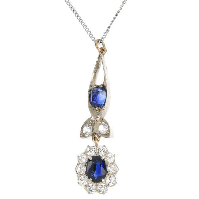 Three gem-set pendants.
