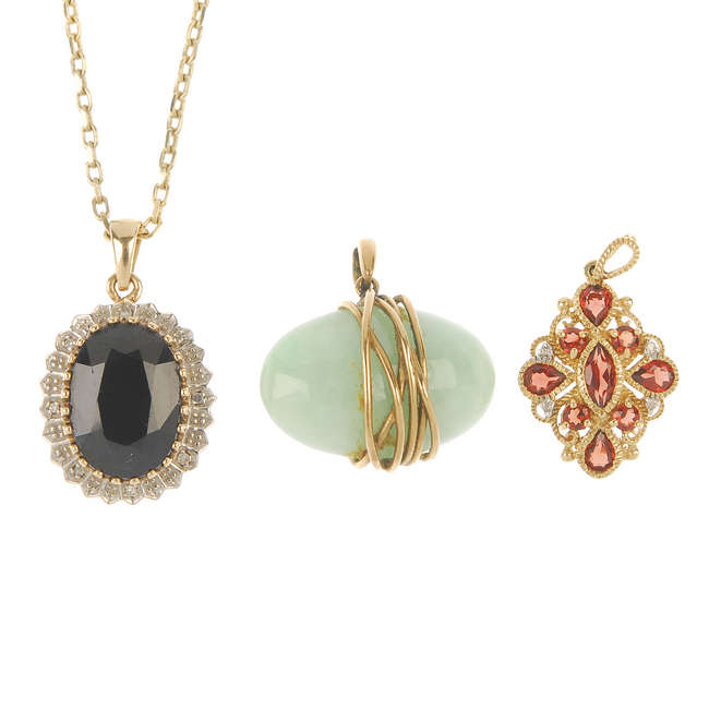 A selection of three 9ct gold gem-set pendants.