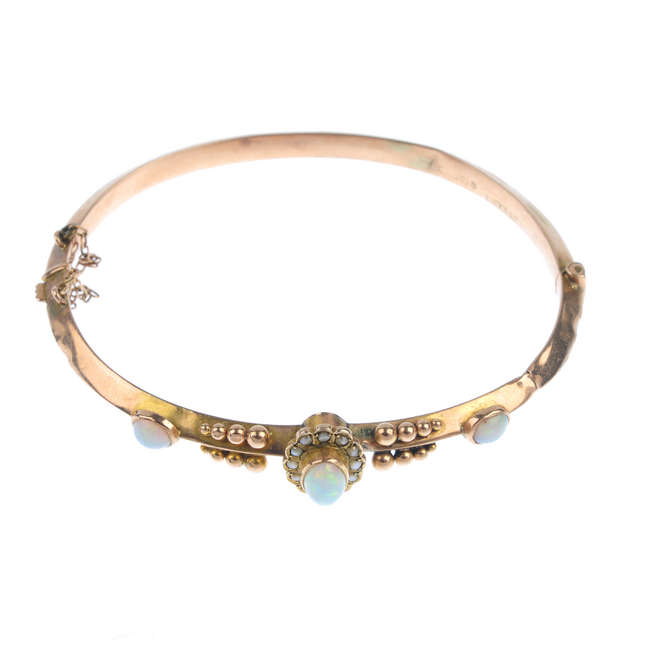 A late Victorian 9ct gold opal and split pearl hinged bangle.