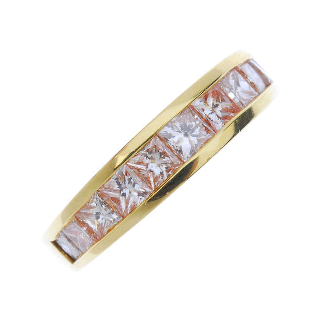 A 'brownish-pink' diamond half-circle eternity ring.