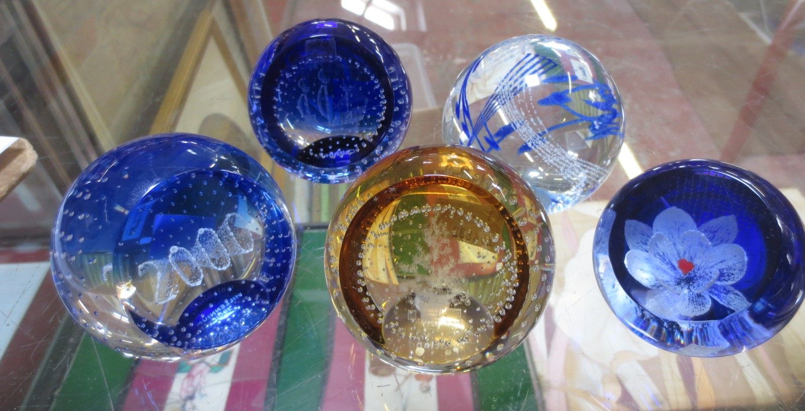 Five Caithness glass paperweights.