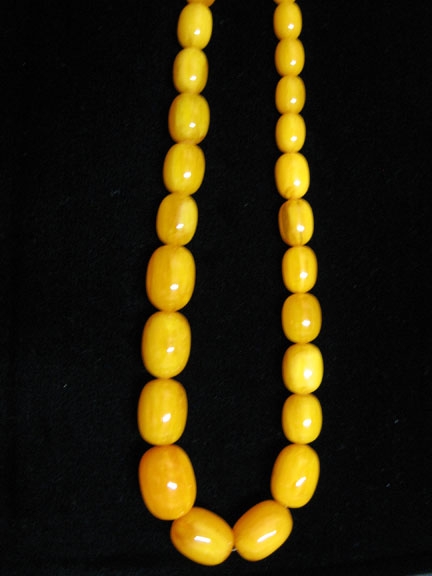 Graduated oval amber bead necklace, Graduated oval amber beads strung without clasp.