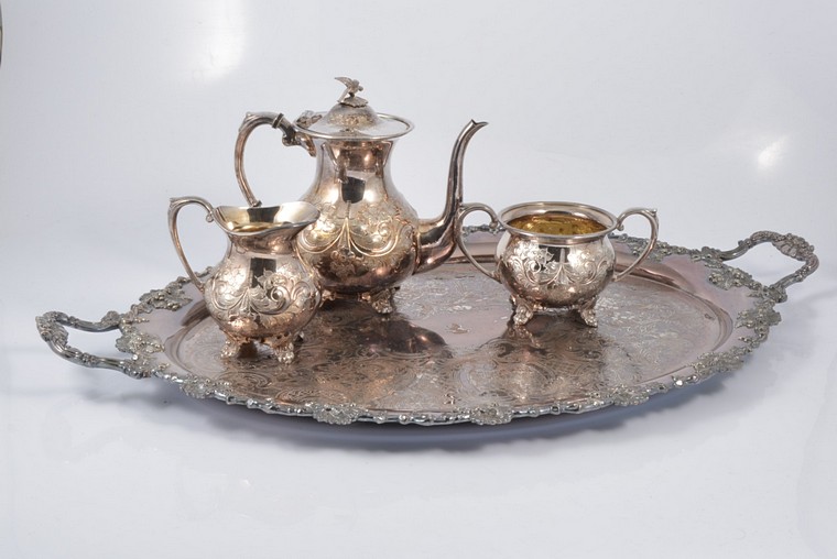 Pair of antique English silver sugar tongs; three other pairs of silver-plated sugar tongs; three plated decanter labels; four-piece silver-plated teaset including tray; also a pair of pedestal bowls