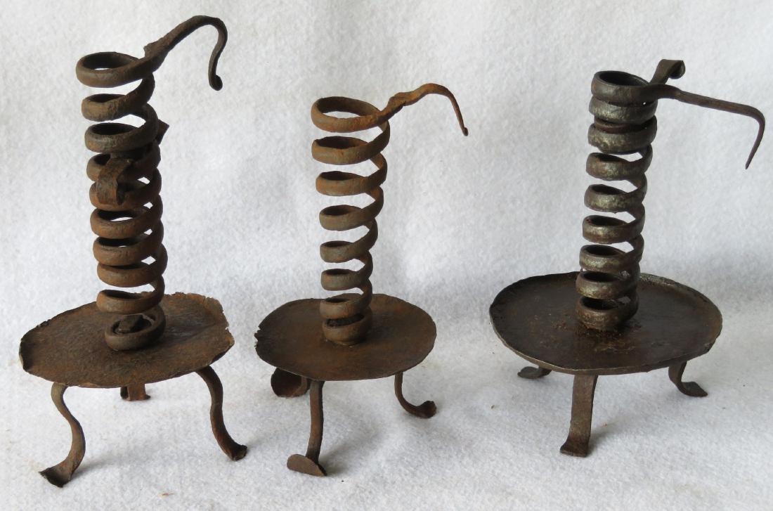 Three 18th century hand forged iron spiral candlesticks