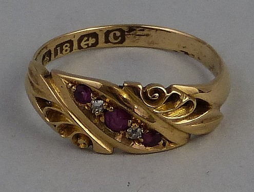 An Edwardian five stone ruby and diamond ring, the small stones set in line