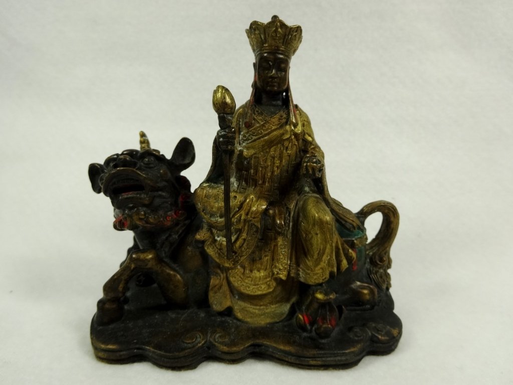 PATINATED BRONZE SCULPTURE, BUDDHA RIDING FOO LION