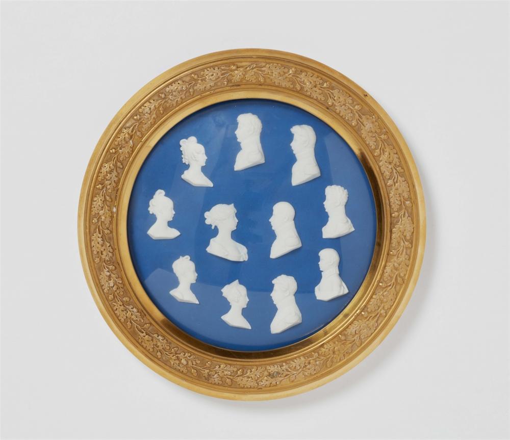 A framed Berlin KPM porcelain plaque with portraits of the Prussian royal family