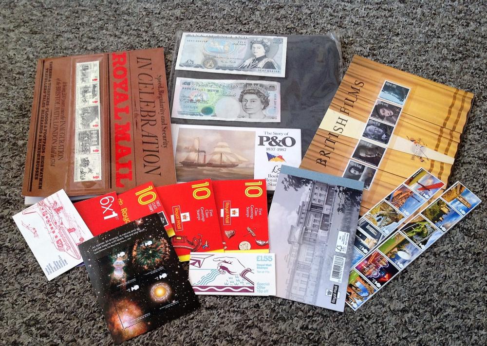 Assorted stamp collection. Includes stamp booklets and mint stamps which can be used for postage.