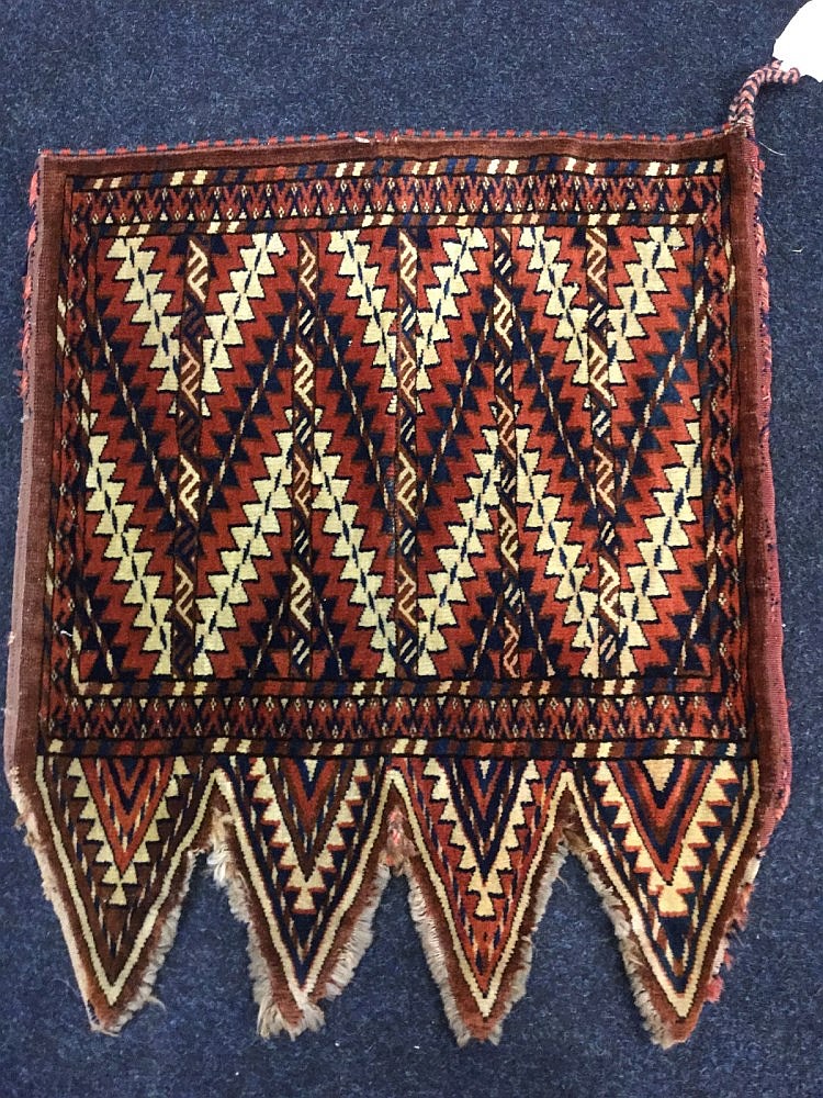 An antique Yamud Okbash, the pendant woven with serrated bands on