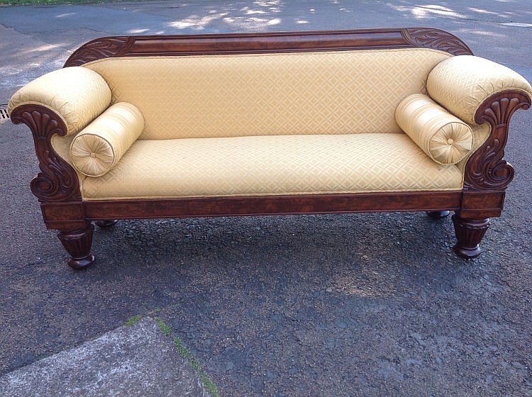 A William IV mahogany sofa, the carved frame with leaf scrolled panels