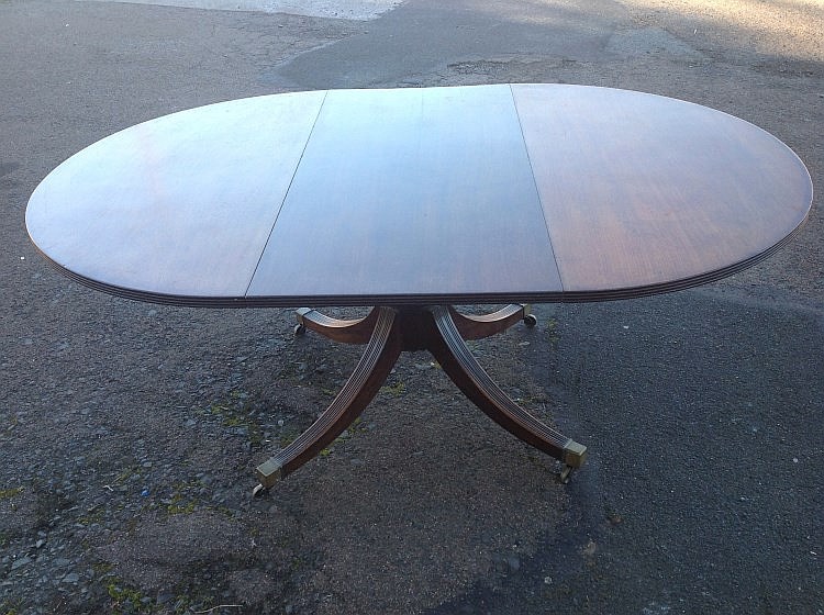 A Georgian mahogany extending dining table, the reeded top with 'D'